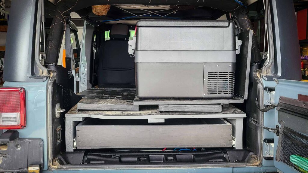 Rear view of an RV cooler and a shelf platform and drawer in a Jeep Wrangler JKU