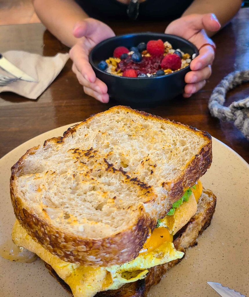 breakfast sandwich and a yogurt bowl